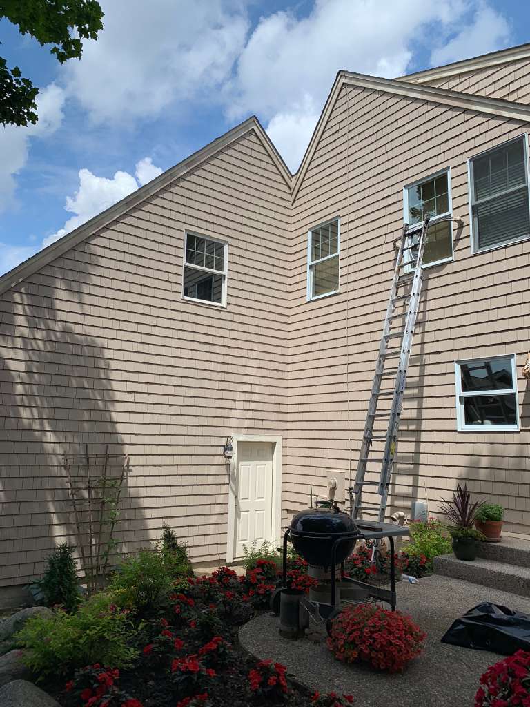 Tan shingle siding home after exterior painting